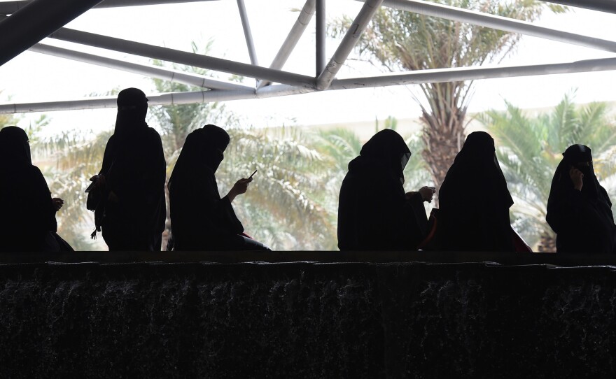 Saudi women wait for their drivers outside a hotel in the Saudi capital Riyadh.