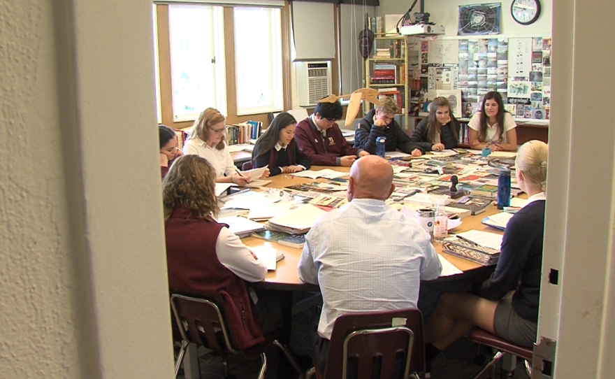 Students sit around a large, round table in their English class at The Bishop's School, March 28, 2017.