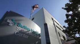 In this Sept. 20, 2019, file photo, an American flag flutters in the breeze outside of the Sutter Medical Center in Sacramento, Calif.