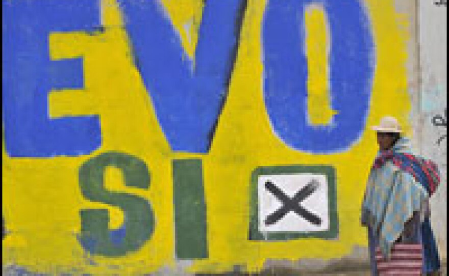 A woman passes by a wall painted with propaganda supporting Morales, in El Alto on Friday.