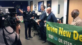 A San Diego police officer asking the protesters to vacate Rep. Scott Peters office on Sept. 26, 2019. 