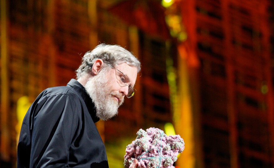 George Church, a professor of genetics at Harvard Medical School, seen looking at a molecular model, says an effort to create synthetic humane genomes could someday have medical applications.