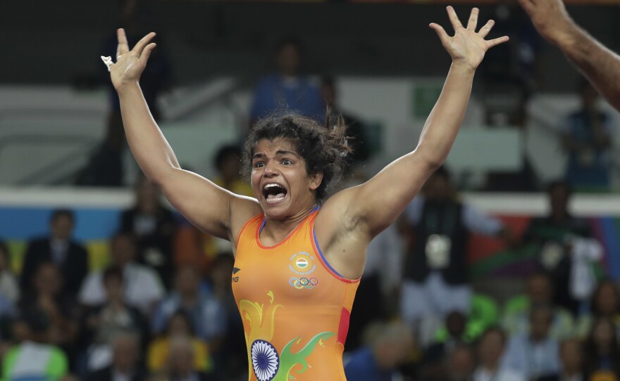India's Sakshi Malik reacts after winning bronze in the women's wrestling freestyle competition.