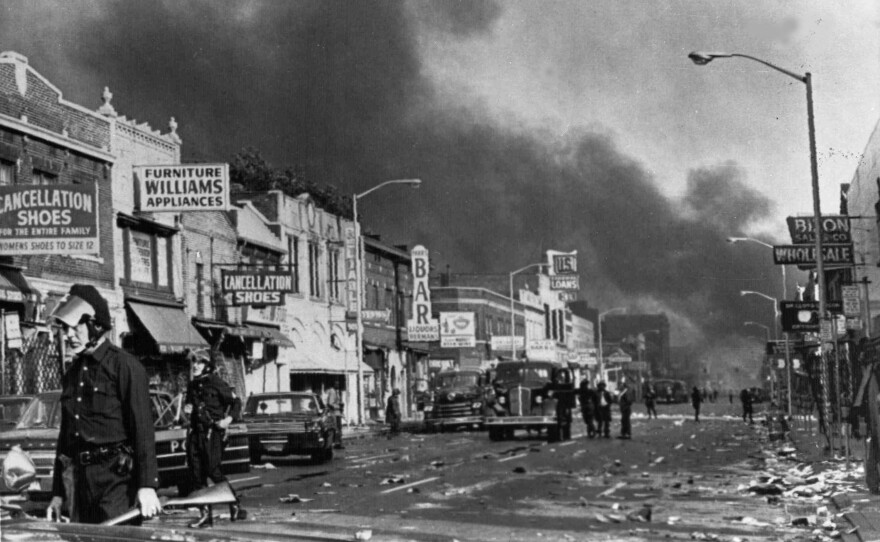 Police check buildings in Detroit on July 24, 1967, following racial riots which broke out in the city. The last surviving member of the Kerner Commission says he remains frustrated that the panel's recommendations on U.S. race relations and poverty were never adopted.