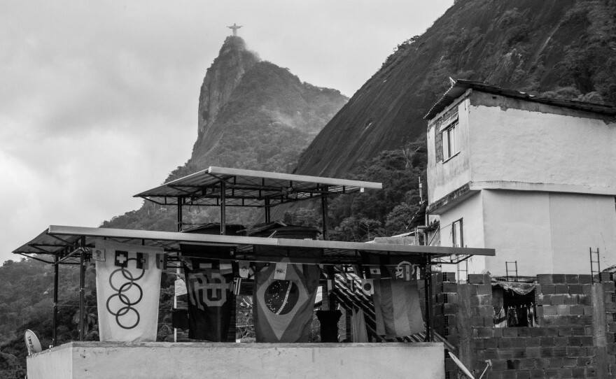 The Christ the Redeemer statue is visible above the Santa Marta favela in Rio de Janeiro.