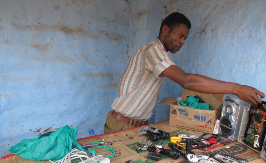 Ali Daud Omar will repair your cell phone for $6. He's one of the refugees benefiting from the Ugandan government's right to work policy.