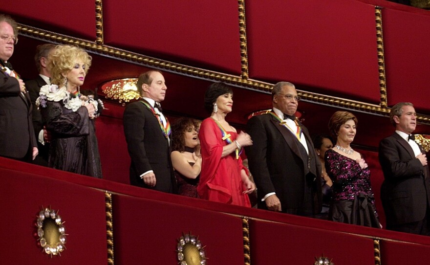 Honorees (from left) James Levine, Elizabeth Taylor, Paul Simon, Chita Rivera and James Earl Jones stand beside first lady Laura Bush and President George W. Bush during the 25th Kennedy Center Honors in 2002. Rivera was the last Hispanic recipient of the award.