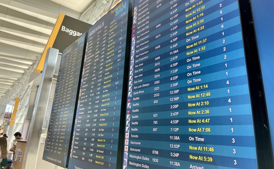 Screens with flight times and statuses are displayed inside San Diego International Airport's Terminal 2, Nov. 6, 2025.