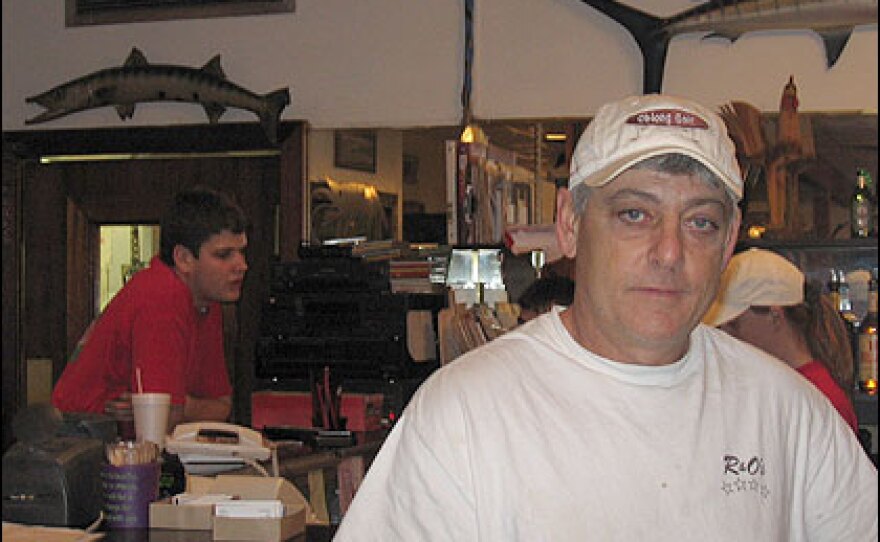 Roland Mollere stands at the bar of R&O's, a restaurant he owns in Bucktown.