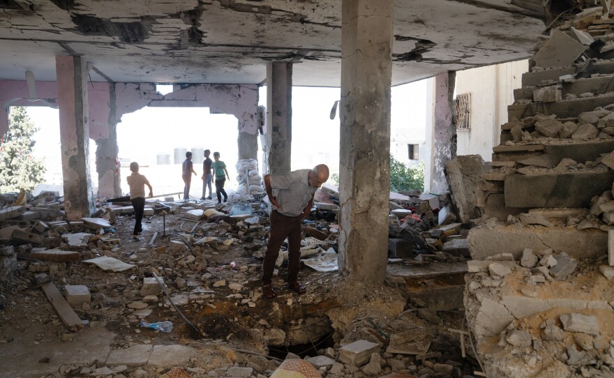 People walk through the ruins of Al-Ansar Mosque in Jenin refugee camp in the northern occupied West Bank that was hit last week by an Israeli airstrike.