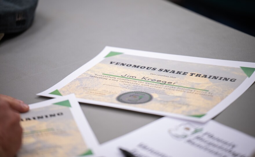 Cale Morris presents rattlesnake class attendees with certificates after class at the Florence Ely Nelson Desert Park in Scottsdale, Arizona.
