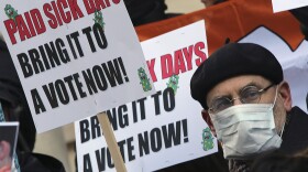 Activists hold signs during a rally for paid sick leave at New York's City Hall last year.