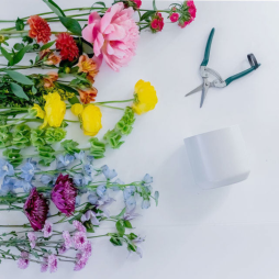 Flower Arranging 101 Workshop - Image of different color flowers on the left and pruning shears and a white vase on the right