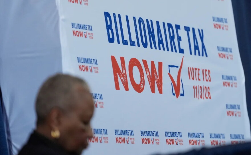 A sign displayed at the Billionaire Tax Now booth at the 2026 California Democratic Party State Convention in San Francisco on Feb. 21, 2026.
