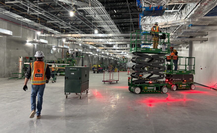 Workers continue construction on one of four main data center buildings at the Project Lighthouse complex in Port Washington, Wis. Thousands of contractors are working on the facility, bringing revenue to local businesses and traffic to city roads.
