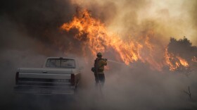 Firefighter Raymond Vasquez battles the Silverado Fire Monday, Oct. 26, 2020, in Irvine, Calif. 