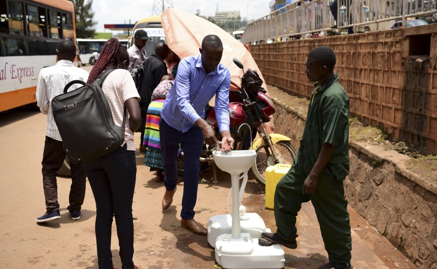 A public hand-washing station for passengers boarding a bus was set up as a cautionary measure against the coronavirus at Nyabugogo Bus Park in Kigali, Rwanda. The photo was taken on March 11, 2020.