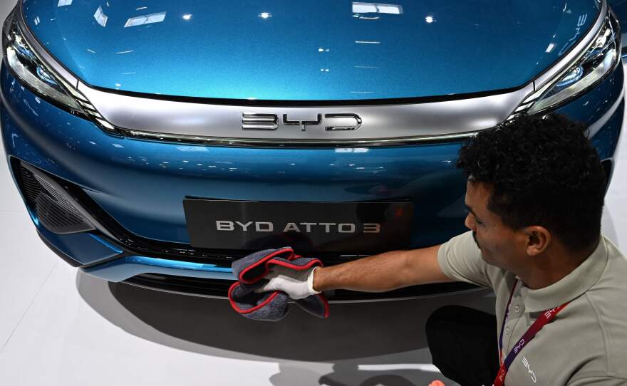A man polishes an Atto 3 car from Chinese car maker BYD at the International Motor Show (IAA) in Munich, Germany, on Sept. 4, 2023. The car has gained in popularity among Europeans.
