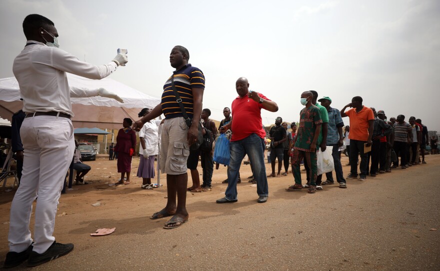 People get their temperatures taken at the border between Abuja and the Nasarawa State, Nigeria, on March 30. African countries are working to prepare for the rise in cases of COVID-19 as the coronavirus spreads on the continent.