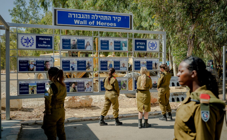 Israeli soldiers visit a memorial commemorating security personnel who died defending those who came under attack at the Nova festival site.