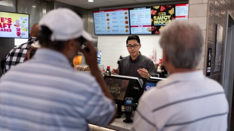 Lawrence Cheng, whose family owns seven Wendy's locations south of Los Angeles, takes orders from customers at his Wendy's restaurant in Fountain Valley on June 20, 2024.