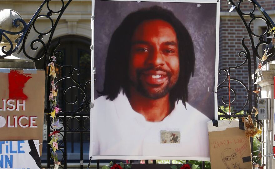 A memorial with a photo of Philando Castile adorns the gate to the governor's residence in St. Paul, Minn., in 2016.