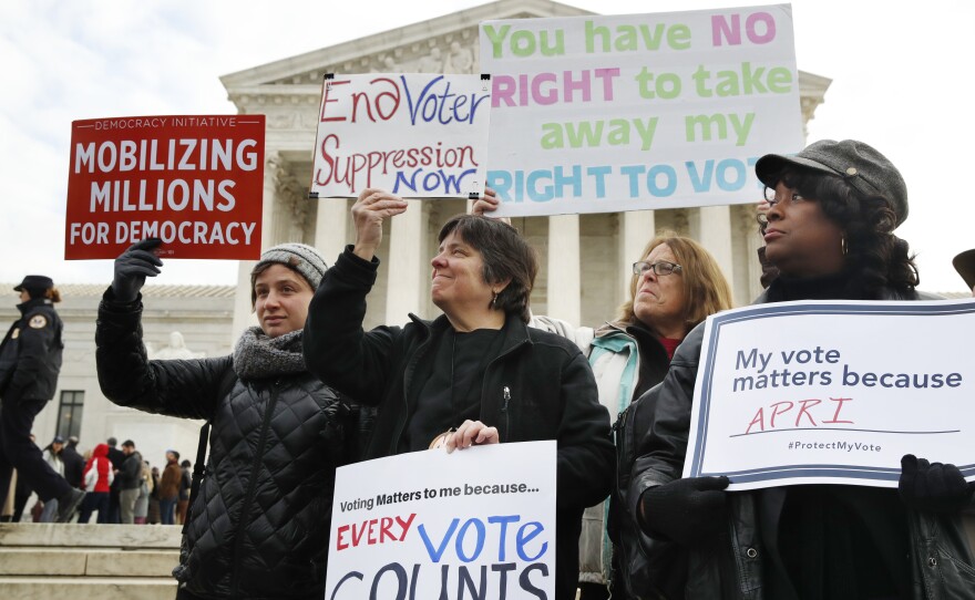 People rally outside of the Supreme Court in opposition to Ohio's voter roll purges in January. The court upheld the controversial law Monday.