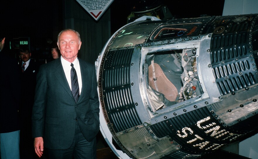 During his campaign for the Democratic presidential nomination, American politician and former astronaut Sen. John Glenn poses beside the Friendship 7 space capsule at the U.S. Space & Rocket Center, Huntsville, Ala., Jan. 18, 1984.