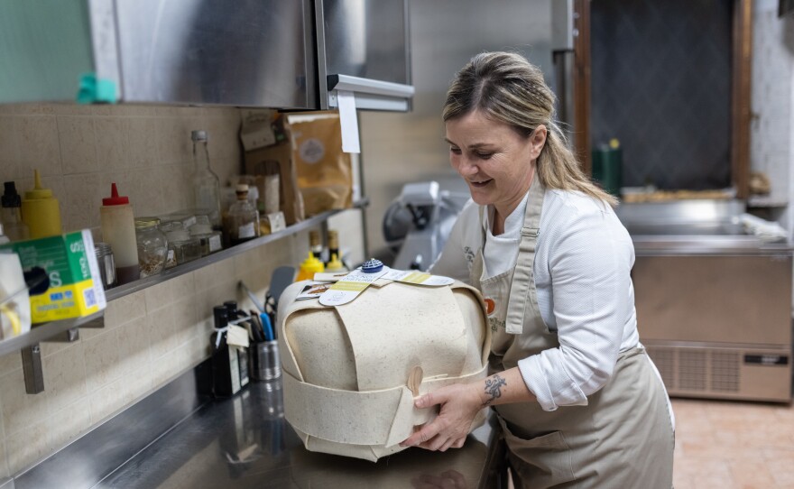 Tiziana Tacchi, Best Italian Host for Slow Food Italy, shows her cooking container in the kitchen of her restaurant in Chiusi, Nov. 12.