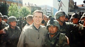 Fabian Rebolledo, Kosovo combat veteran with the Army's 82nd Airborne division, stands with former Secretary of Defense William S. Cohen. Rebolledo has since been deported.