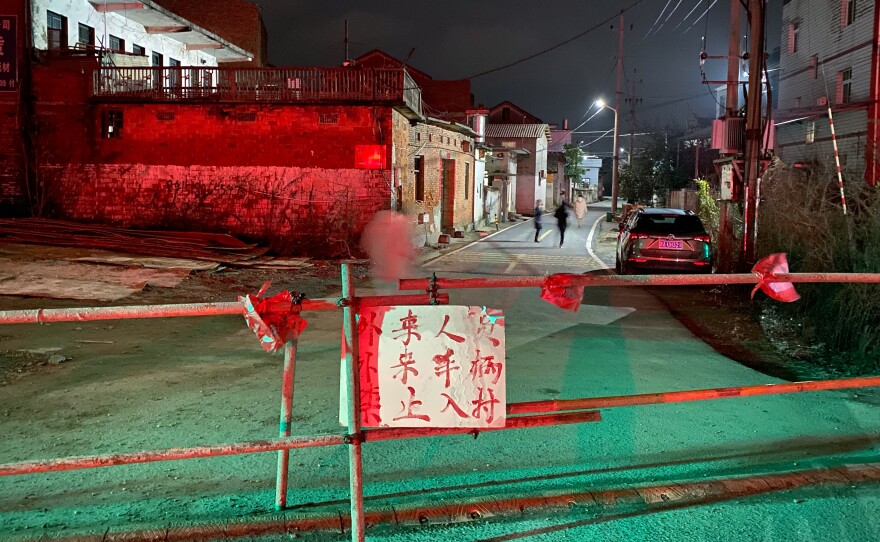 Villagers just outside the city of Nanchang, Jiangxi, erected their own blockade with a sign that says, "Outside people and cars forbidden from entering." Residents say hundreds of migrant workers returned from Wuhan for the Lunar New Year holiday and are now not allowed to leave.