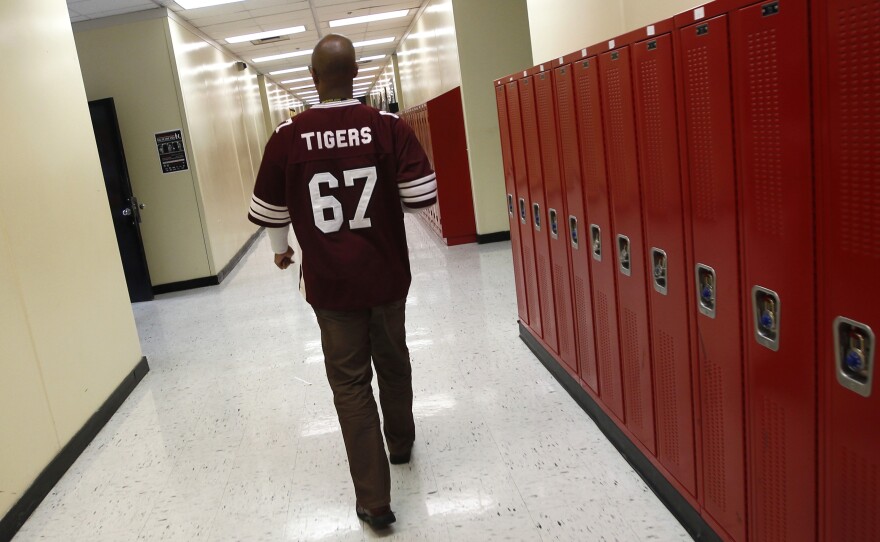 Walter H. Dyett High School principal Charles Campbell tours the school in Chicago in 2012. The bipartisan education reform movement sweeping the nation calls for rating schools by their students' test scores and then taking drastic steps to overhaul the worst performers by firing the teachers, turning the schools over to private management or shutting them down altogether.