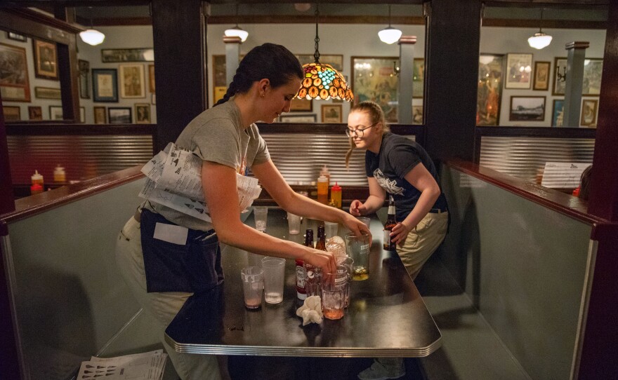 Servers clear off a booth at Hickory Park. Like much of the Midwest, Iowa hasn't typically attracted a lot of newcomers, and its population has been stable for a long time, says Iowa State economist Peter Orazem. That contributes to the tight job market.