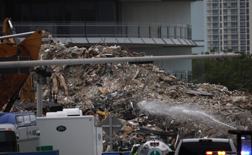 Excavators dig through the pile of the Champlain Towers South debris on July 13, 2021.