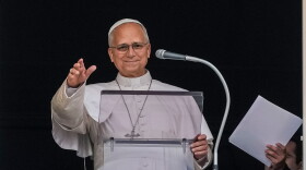 Pope Leo XIV appears at the window of his study in the Apostolic Palace overlooking St. Peter's Square at the Vatican for the traditional noon blessing after praying the Angelus, Sunday, Oct. 18, 2026, a day after he returned from the hospital, where he had lung cancer removed on Tuesday.