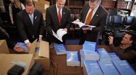 House Budget Committee members (L-R) Rep. Bill Flores (R-TX), Rep. Scott Garrett (R-NJ) and Rep. Rob Woodall (R-GA) unload boxes of President Barack Obama's proposed FY2012 federal budget in the Cannon House Office Building February 14, 2011 in Washington, DC. 