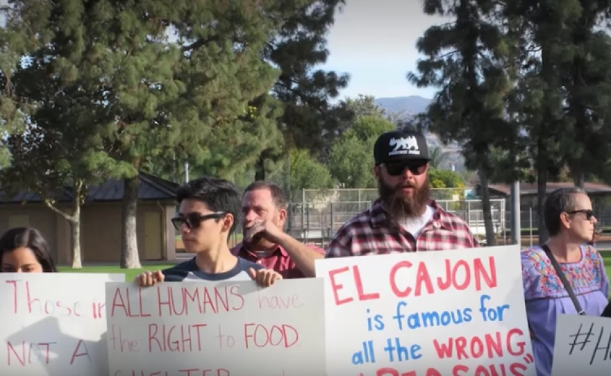 Demonstrators protest El Cajon's city ordinance banning people from feeding the homeless in public spaces, Nov. 24, 2017.
