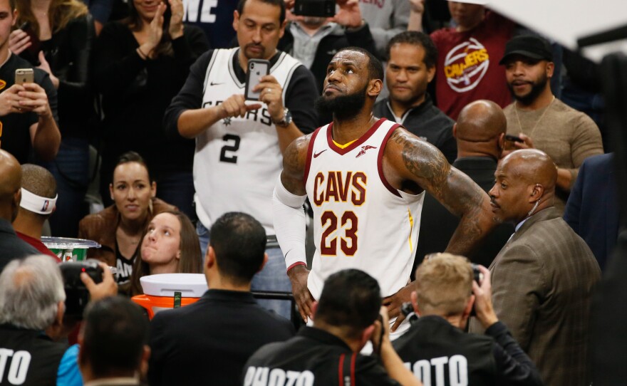 Cleveland Cavaliers LeBron James celebrates after scoring his 30,000 career point during a time out against the Spurs at AT&T Center in San Antonio Tuesday night.