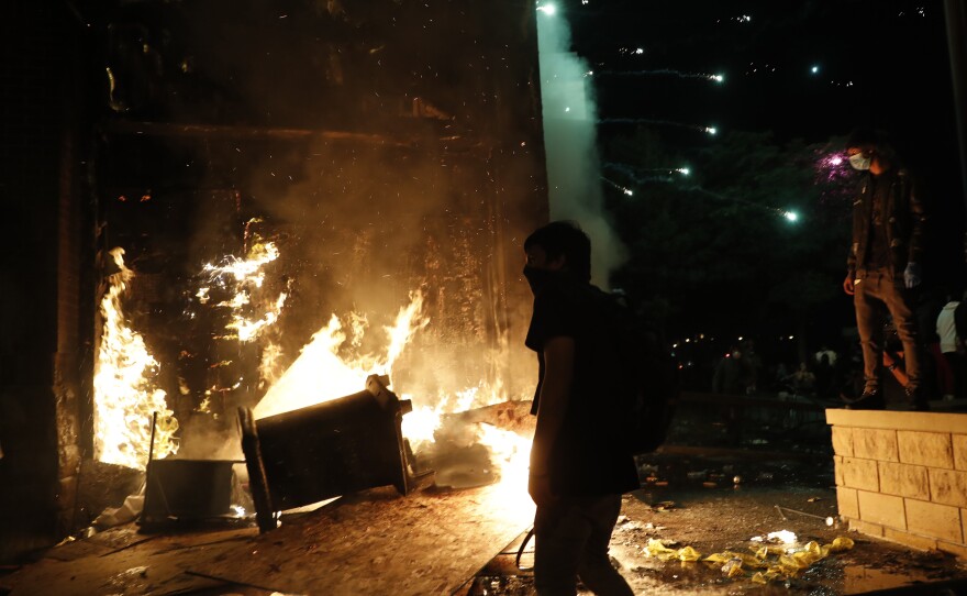 Protesters set fires at the 3rd Precinct of the Minneapolis Police Department on Thursday. Protests over the death of George Floyd, the black man who died in police custody, continued in Minneapolis for a third straight night.