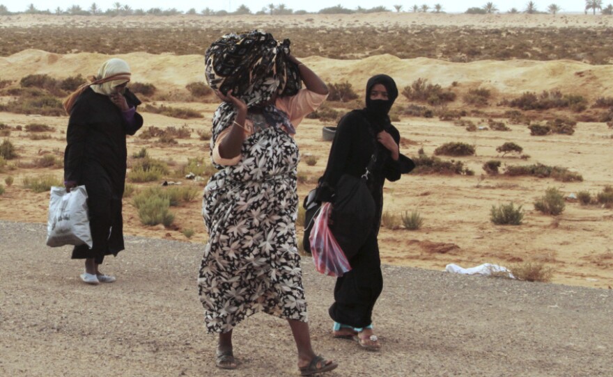 Libyans flee on foot along the main road heading west, away from Sirte, on Tuesday. Sirte, cut off from the rest of the country, is the last major town controlled by forces loyal to toppled dictator Moammar Gadhafi.