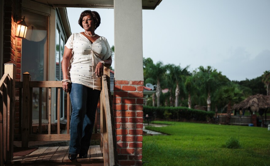 Attorney Ermence Parent on the porch of her New Orleans home. Two hip replacements eased Parent's pain and got her exercising again, she says. A doctor at one of the city's newly renovated clinics made the diagnosis.