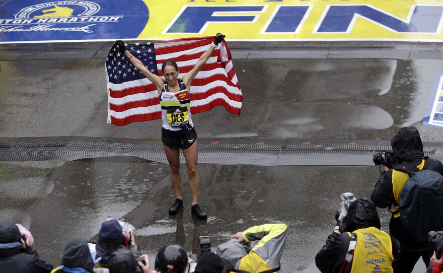 Desiree Linden, of Washington, Mich., celebrates after winning the women's division of the 122nd Boston Marathon on Monday, April 16, 2018, in Boston.