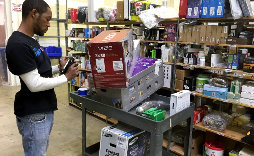 Employee Marvin Whitehead scans returned items so they can be resold at the Optoro warehouse in Lanham, Md.