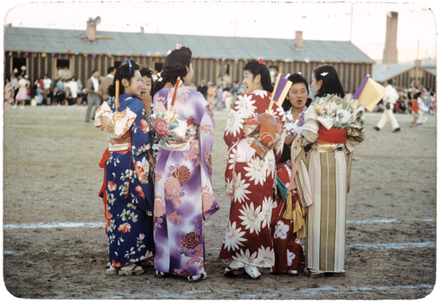 Young women wearing kimonos chat during an Obon celebration honoring ancestors at the Heart Mountain Relocation Center in Wyoming.