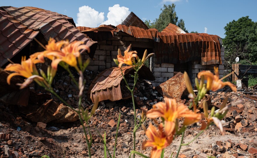 A destroyed building next to flowers on Thursday in Borodianka, Ukraine. The region around Ukraine's capital continues to recover from Russia's aborted assault on Kyiv, which turned many communities into battlefields.