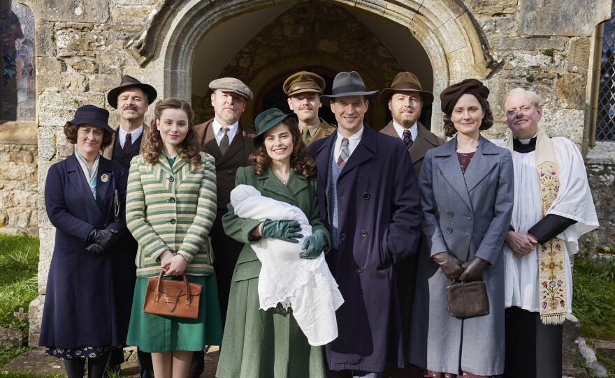 Shown L-R: Hannah Herriot (Gabriel Quigley), James Herriot Sr (Drew Cain), Jenny Alderson (Imogen Clawson), Richard Alderson (Tony Pitts), Helen Herriot (Rachel Shenton), Tristan Farnon (Callum Woodhouse), James Herriot (Nicholas Ralph), Siegfried Farnon (Samuel West), Mrs. Hall (Anna Madeley), Vicar (Mark Chatterton). MASTERPIECE ALL CREATURES GREAT AND SMALL Season 5
