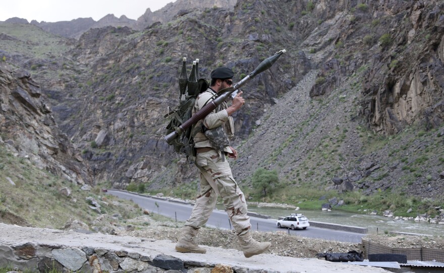 An Afghan soldier walks at a checkpoint last month on the outskirts of Kabul, Afghanistan.