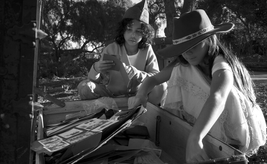 Elle Barnes,10, wears her Great Great Grandfather's U.S. army cap as she sifts through the contents of the trunk with her cousin Keala Sabla, 10, on Thanksgiving day in Los Angeles, CA.