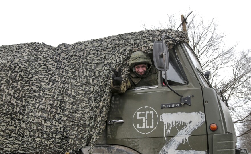 A serviceman waves from a military truck painted with the letter "Z" in Mykolaivka in the Donetsk region, a territory controlled by pro-Russian militants in eastern Ukraine, on Feb. 27.