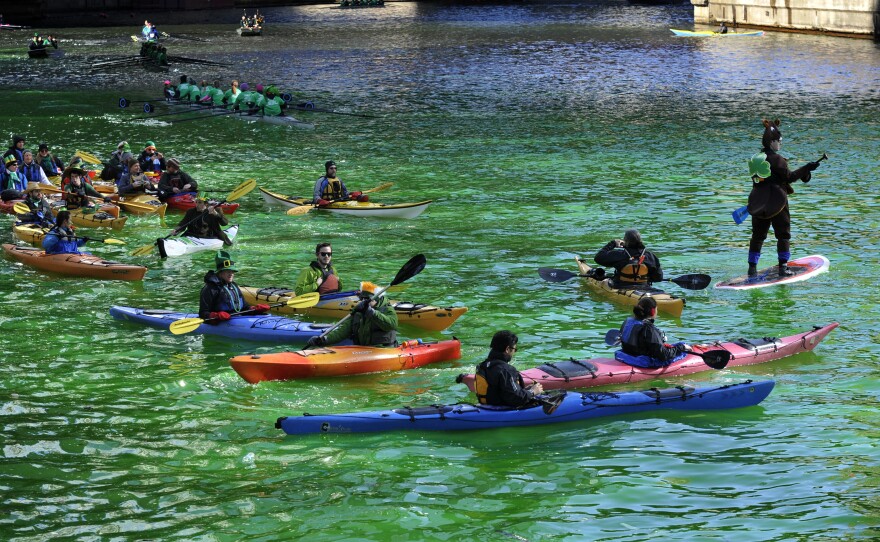 Kayakers float on the Chicago River after it was dyed green ahead of the St. Patrick's Day parade on March 15, 2014.